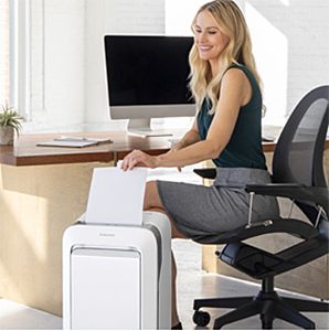 Photo of a woman using a shredder